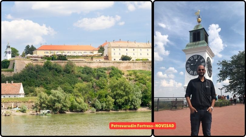 A man standing in front of Petrovaradin Fortress, showcasing its impressive architecture and panoramic views of the Danube River.