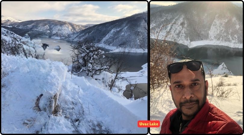 A man standing in front of Uvac Lake, surrounded by stunning natural landscapes and meandering waters.